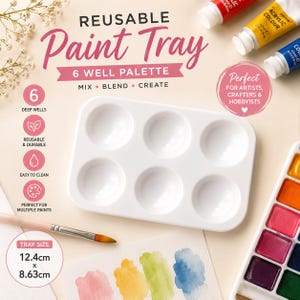 May include: A white rectangular paint tray with six deep wells, labelled as a reusable 6 well palette. The text reads Reusable Paint Tray, 6 Well Palette, Mix, Blend, Create, and Tray Size 12.4cm x 8.63cm. Includes a paintbrush and paint tubes.