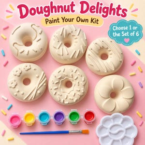 May include: A Doughnut Delights Paint Your Own Kit featuring six unpainted ceramic doughnut shapes with various embossed designs, a strip of six acrylic paint pots in bright colours, a paintbrush, and a white flower-shaped paint palette.