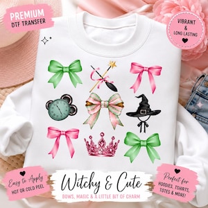 May include: A white sweatshirt featuring a DTF transfer print of various icons including green and pink bows, a magic wand, a clock, a witch hat, and a crown. The text reads "Witchy & Cute" along with "PREMIUM DTF TRANSFER" and "VIBRANT & LONG LASTING".