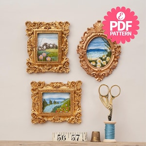 May include: Three gold-framed embroidery patterns of landscapes, including a mountain scene, a beach scene, and a forest scene. The frames are ornate and have a vintage feel. The patterns are perfect for needlepoint or cross-stitch projects.