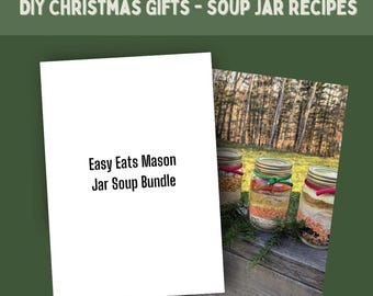 May include: Image features a white card with the text "Easy Eats Mason Jar Soup Bundle" next to three mason jars filled with layered ingredients. The jars have colorful ribbons and are set against a natural outdoor backdrop.