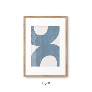 May include: A framed abstract art print with a blue and white geometric design. The print features overlapping circles in shades of blue on a white background. The frame is made of natural wood.