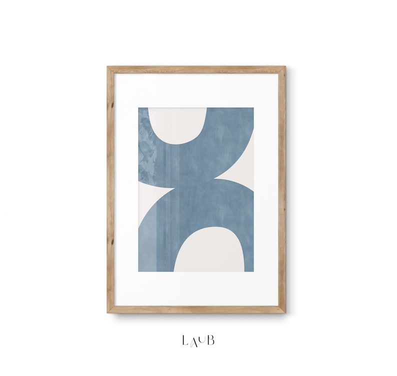 May include: A framed abstract art print with a blue and white geometric design. The print features overlapping circles in shades of blue on a white background. The frame is made of natural wood.