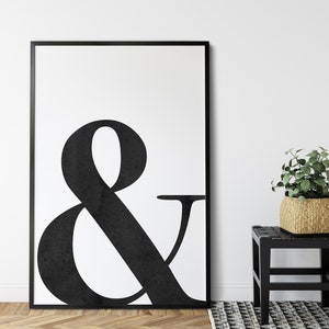May include: Black and white ampersand symbol print in a black frame. The print is on a white background and the ampersand is in a bold, stylized font.