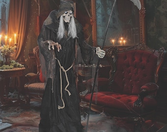 May include: A life-sized grim reaper figure wearing a black hooded robe with a rope belt, long white hair, and a skeletal face. The figure holds a tall black staff topped with a large, curved silver scythe blade in its bony, articulated hands.