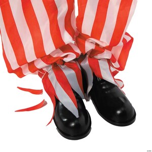 May include: A pair of black, shiny clown shoes with red and white striped pants. The pants are gathered at the ankles and have a ruffled appearance. The image is set against a white background.