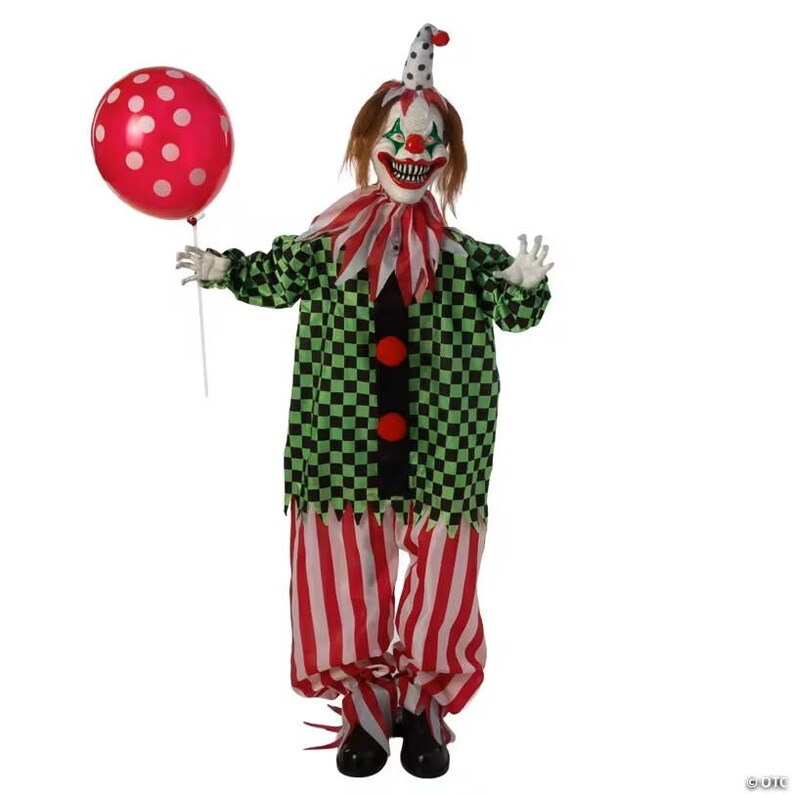 May include: A creepy clown figure with a menacing grin, wearing a green and black checkered jacket, red and white striped pants, and a polka-dot hat. The clown holds a red balloon with white polka dots. A Halloween decoration.
