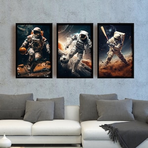 May include: Three framed prints of astronauts playing different sports in space. The astronaut in the left print is playing basketball, the astronaut in the middle print is playing soccer, and the astronaut in the right print is playing baseball.