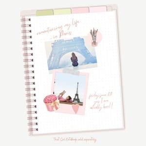 May include: A pink and white spiral bound notebook with a dotted pattern. The notebook has a pink and white floral sticker, a pink heart sticker, and two photos of the Eiffel Tower. The text "reminiscing my life in Paris" is written in pink cursive on the cover. The text "Friday June 28 yes I am actually here!!" is written in pink cursive on the page.