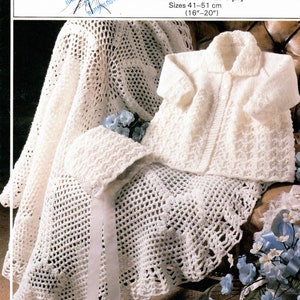 May include: White crochet shawl, bonnet, and cardigan set. The shawl has a scalloped edge and a white ribbon. The cardigan has a button closure and a collar. The set is made of 4 ply yarn and is suitable for sizes 41-51 cm.