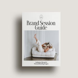 May include: A book cover with the title "Brand Session Guide" in a serif font. The cover features a photo of a person reclining on a white sofa, holding a magazine. The text "Authentic, Elevated & Personal Branding Imagery" is at the bottom.