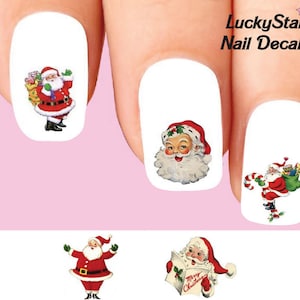 May include: Nail decals featuring Santa Claus in various poses. The decals include Santa with a sack of gifts, holding a candy cane, and reading a Christmas card. The text "LuckyStar Nail Decals" is also visible.