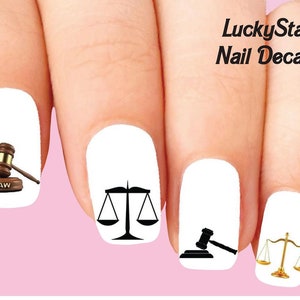 May include: Nail decals featuring law-themed designs. Includes a gavel, scales of justice, and the word "LAW" on a wooden block. The decals are on a white background with a pink backdrop, and the text "LuckyStar Nail Decals".
