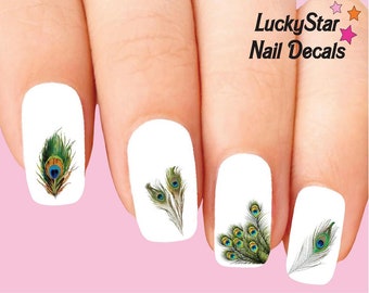 May include: Nail decals featuring peacock feather designs in shades of green, blue, and gold. The decals are applied to white nail polish. The text "LuckyStar Nail Decals" is visible in the upper right corner.