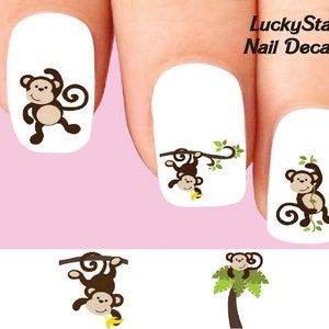 Könnte beinhalten: Nagelaufkleber mit Cartoon-Affen in verschiedenen Posen. Die Affen sind braun mit hellbraunen Gesichtern und werden beim Schwingen an Lianen, beim Halten von Bananen und beim Stehen gezeigt. Der Text "LuckyStar Nail Decals" befindet sich in der oberen rechten Ecke.