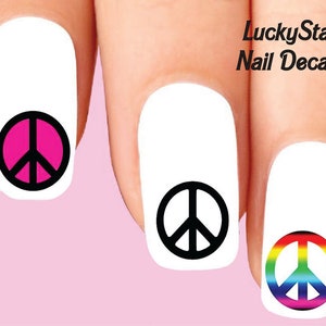 May include: Nail decals featuring peace symbols in pink, black, and rainbow colors. The decals are applied to white nail polish. The text "LuckyStar Nail Decals" is visible in the upper right corner.