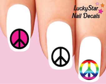 May include: Nail decals featuring peace symbols in pink, black, and rainbow colors. The decals are applied to white nail polish. The text "LuckyStar Nail Decals" is visible in the upper right corner.