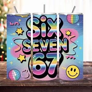 May include: A set of three stainless steel tumblers with a retro design. The tumblers feature the words "SIX SEVEN 67" in a colorful, bubble-style font, along with stars, a smiley face, and disco balls. Each tumbler has a silver lid and a straw.