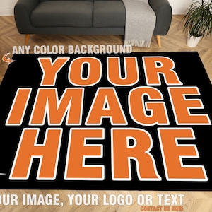 May include: A black and orange rug with the text "YOUR IMAGE HERE" in white. The text is in a bold, sans-serif font. The rug is designed to be personalized with an image, logo, or text.