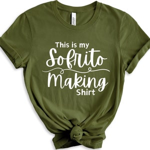 May include: A green t-shirt with white text that says "This is my Sofrito making Shirt".