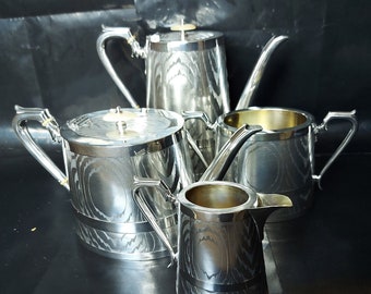 Victorian Aesthetic Movement Four Piece Chased Silver Bark Silver Plated Tea Set. C.1873.