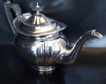 James Deakin & Sons T5038 Bombe Silver Plated Ribbon and Reed Decorated Oval Teapot.  Circa 1910.