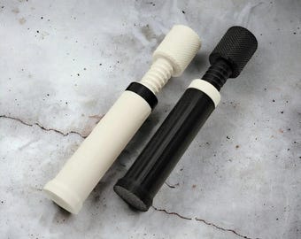 Pode incluir: Duas ferramentas cilíndricas com botões de ajuste roscados no topo. Uma ferramenta é principalmente branca com um anel preto, enquanto a outra é preta com um anel branco. Ambas apresentam superfícies de aderência texturizadas e serrilhadas.