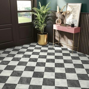 May include: A black and white checkered floor with a pink console table with gold legs and a potted plant in a gold pot.