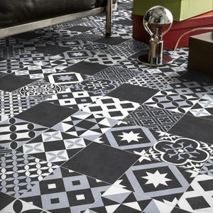 May include: Black and white patterned floor tiles in a variety of geometric designs. The tiles are arranged in a patchwork pattern.