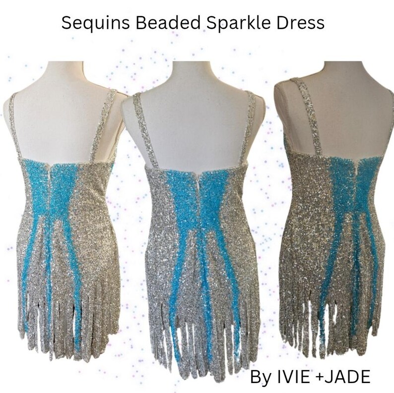 May include: A sleeveless dress featuring silver sequins and beads with a vertical bright blue panel down the center. The hem is finished with long silver fringe. The text "Sequins Beaded Sparkle Dress" and "By IVIE +JADE" is visible.