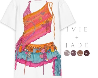 May include: White t-shirt featuring a colorful illustration of a two-piece outfit. The top is orange and pink with embellishments, and the skirt is blue and pink with decorative elements. The text "IVIE + JADE" is on the right.