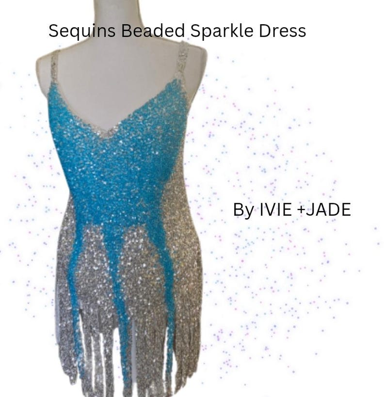 May include: A sleeveless dress featuring a V-neckline, adorned with silver and bright blue sequins and beads. The garment includes a fringe hemline and displays the text Sequins Beaded Sparkle Dress By IVIE + JADE on a white background.