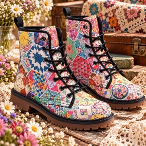 May include: A pair of ankle boots featuring a colorful patchwork quilt pattern with various geometric shapes in shades of pink, blue, yellow, and green. The boots have black laces, black eyelets, black trim, and a thick brown lug sole.
