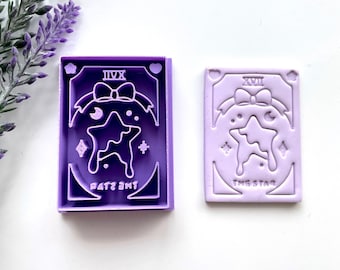 May include: Two purple rubber stamps with a star design and the text "The Star" and "XVII" on one and "The Star" and "IX" on the other.