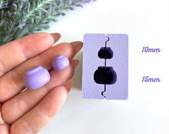 May include: Purple silicone mold for making resin crafts. The mold has two cavities, one measuring 10mm and the other 15mm. Two purple resin pieces are shown next to the mold.
