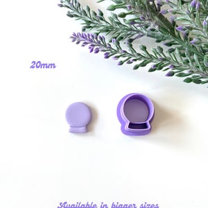 May include: Purple plastic cookie cutters in the shape of a snow globe. The smaller cutter is 20mm in diameter. Available in bigger sizes.