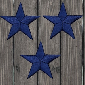 May include: Three navy blue felt star-shaped patches. The stars are five-pointed and have a slightly textured surface.