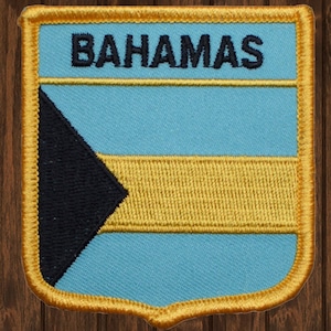 May include: A blue, black, and gold embroidered patch with the word "BAHAMAS" in black lettering.