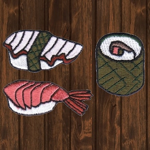 May include: Three embroidered sushi patches, including a maki roll, a nigiri with shrimp, and a nigiri with a green seaweed topping.