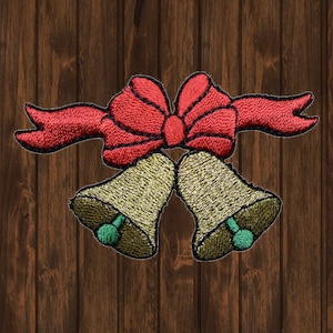 May include: Two gold bells tied together with a red bow. The bells have green accents.