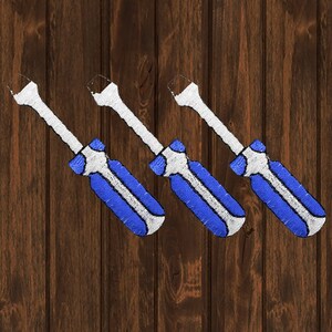 May include: Three white and blue screwdrivers with black handles against a woodgrain background.