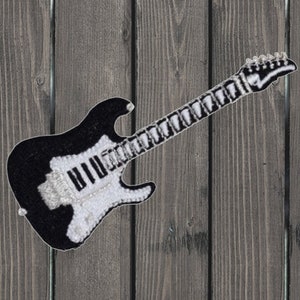 May include: Black and white embroidered electric guitar patch. The guitar has a white pickguard and a black body. The patch is perfect for adding a rock and roll touch to clothing, bags, or other accessories.