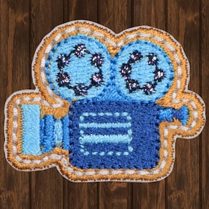 May include: Blue and gold embroidered iron-on patch of a vintage movie camera.