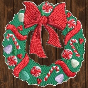 May include: A green Christmas wreath with a red bow, candy canes, and peppermint candies.