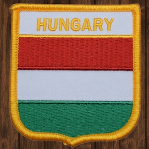 May include: A red, white, and green embroidered patch with a gold border and the word "HUNGARY" in yellow lettering.