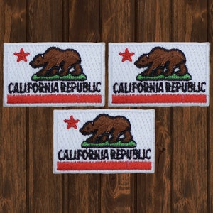 May include: Three white embroidered patches with the California Republic flag design. Each patch features a red star, a brown bear, and the words "CALIFORNIA REPUBLIC" in black.