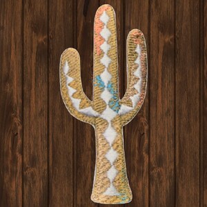 May include: A beige and white cactus shaped rug with a geometric pattern. The rug has a light blue and orange accent colour.