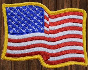 May include: A red, white, and blue American flag patch with a yellow border. The flag is waving in the wind.