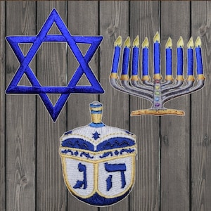 May include: A blue Star of David, a blue and gold menorah with nine candles, and a blue and white dreidel with the Hebrew letters Nun, Gimel, Hey, and Shin.