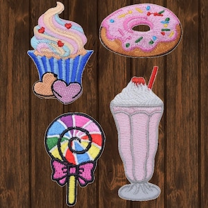 May include: Four embroidered iron-on patches featuring a pink and white cupcake with hearts, a pink and white donut with sprinkles, a pink and white milkshake with a red straw, and a rainbow lollipop with a pink bow.